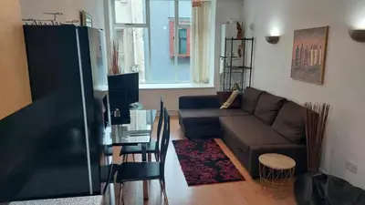 a living room with a couch and a glass table at City-center Flat Sleeps 4 with Balcony in Liverpool