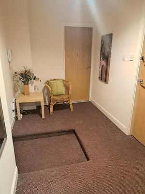 a living room with a chair and a table at City-center Flat Sleeps 4 with Balcony in Liverpool