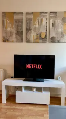 a white table with a television on top of it at Stylish City Centre Stay - 4 mins to station - Fast Wifi - Near Stadiums in Liverpool