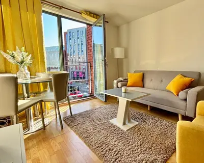 a living room with a couch and a table at Stylish City Centre Stay - 4 mins to station - Fast Wifi - Near Stadiums in Liverpool