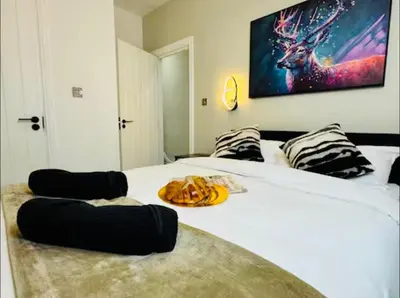 a bed with a plate of food on top of it at The Anfield Snug Terraced, 3 Bedroom Home with Ensuite & Free On-Street Parking in Liverpool