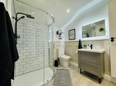 a bathroom with a shower and a toilet and a sink at The Anfield Snug Terraced, 3 Bedroom Home with Ensuite & Free On-Street Parking in Liverpool