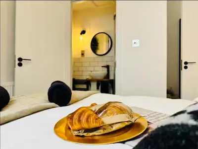 a plate of croissants and bread on a bed at The Anfield Snug Terraced, 3 Bedroom Home with Ensuite & Free On-Street Parking in Liverpool