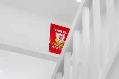 a red sign sitting on top of a white shelf at Steven Gerrard Anfield House 6 bedroom house in Liverpool