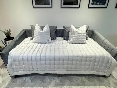 a large white bed with six pillows on it at Kendal By The Coast - Cosy home in great location in Blackpool