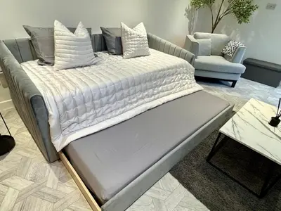 a large bed in a living room with a couch at Kendal By The Coast - Cosy home in great location in Blackpool