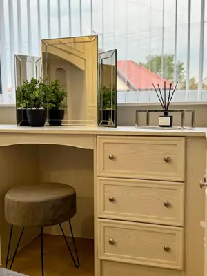 a desk with plants and a mirror and a stool at Kendal By The Coast - Cosy home in great location in Blackpool