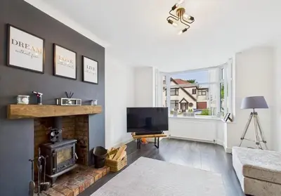 a living room with a fireplace and a television at Kendal By The Coast - Cosy home in great location in Blackpool