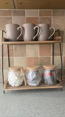 a shelf with bowls and cups and utensils on it at Two bedroom home in quite culdisac over looking hospital in Blackburn