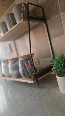 a shelf with dishes on it in a room with a plant at Two bedroom home in quite culdisac over looking hospital in Blackburn