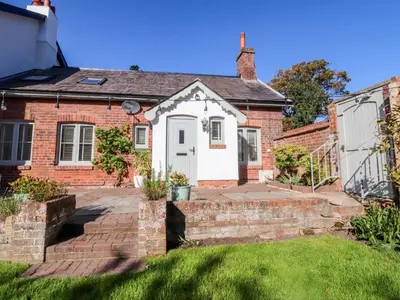 a brick house with a white door at Gardener's Cottage in Lytham St Annes