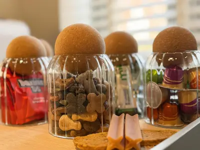 a group of four bottles filled with food and cookies at Gardener's Cottage in Lytham St Annes