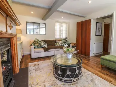 a living room with a couch and a coffee table at Gardener's Cottage in Lytham St Annes