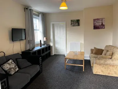a living room with a couch and a table at Preston Central Flats in Preston