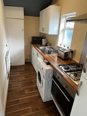 a small kitchen with a washer and dryer in it at Preston Central Flats in Preston