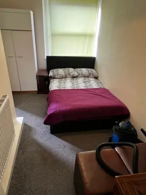a bedroom with a bed with a purple blanket at Preston Central Flats in Preston