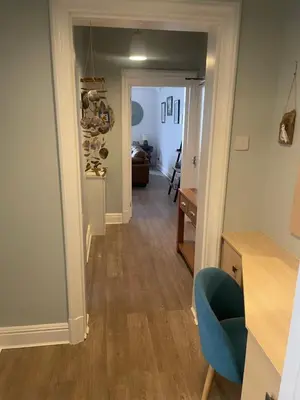 a hallway with a door leading to a living room at Pier View in Lytham St Annes