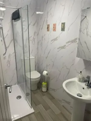 a bathroom with a shower and a toilet and a sink at Pier View in Lytham St Annes