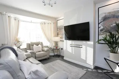 a living room with a couch and a tv at XxHot Tub pleasure beach Sleeps 5 Xx in Blackpool