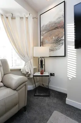 a living room with a couch and a table at XxHot Tub pleasure beach Sleeps 5 Xx in Blackpool
