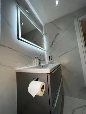 a bathroom with a sink and a roll of toilet paper at XxHot Tub pleasure beach Sleeps 5 Xx in Blackpool