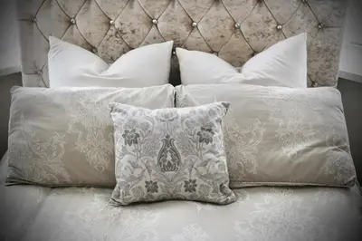 a bed with white pillows and a headboard at XxHot Tub pleasure beach Sleeps 5 Xx in Blackpool