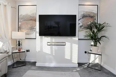 a living room with a flat screen tv on a wall at XxHot Tub pleasure beach Sleeps 5 Xx in Blackpool