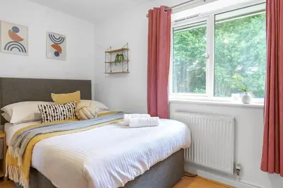 a bedroom with a bed and a window at Cozy Haydock Home With Easy Transport Links in St Helens and Wi-Fi in Haydock