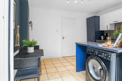 a laundry room with a washer and dryer at Cozy Haydock Home With Easy Transport Links in St Helens and Wi-Fi in Haydock