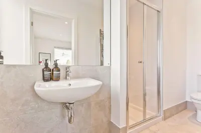 a bathroom with a sink and a shower at Fellbeck Holiday Home - Cartmel in the Lake District in Cartmel