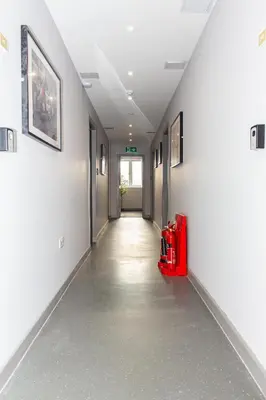 an empty hallway with a red suitcase in a building at Mammut House in Liverpool
