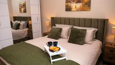 a bedroom with a bed with a tray of fruit on it at Links Apartment, Southport, Englands Golf Coast in Southport