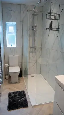 a bathroom with a glass shower with a toilet at Links Apartment, Southport, Englands Golf Coast in Southport