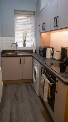 a kitchen with a sink and a washing machine at Links Apartment, Southport, Englands Golf Coast in Southport