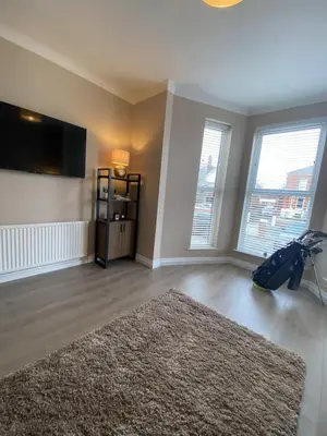 a living room with a rug and a flat screen tv at Links Apartment, Southport, Englands Golf Coast in Southport