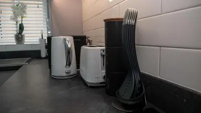 a group of coffeemakers sitting on a counter in a kitchen at Links Apartment, Southport, Englands Golf Coast in Southport