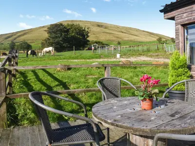 a table with chairs and a field with horses at Croft - Uk50042 in Clitheroe