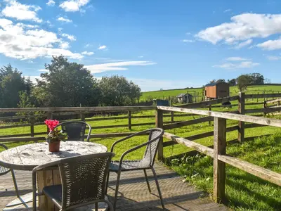 a patio with a table and chairs and a field at Croft - Uk50042 in Clitheroe