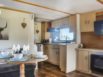 a kitchen with a table and a sink and a stove at Croft - Uk50042 in Clitheroe