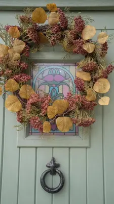 a wreath on the front of a door with a cross at Tastefully decorated 3 bed home in Formby