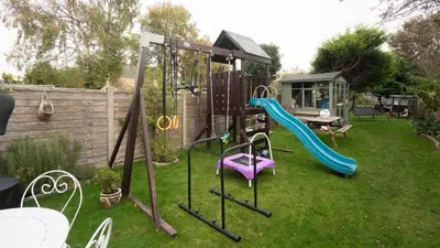 a backyard with a playground with a slide at Tastefully decorated 3 bed home in Formby