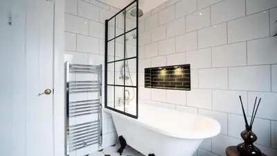 a white bathroom with a sink and a mirror at Tastefully decorated 3 bed home in Formby