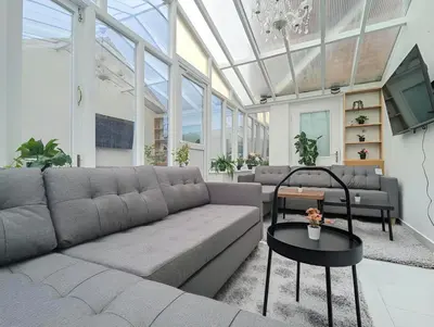 a living room with a couch and a tv at Spacious 5BR Home Near Central Liverpool Parking in Liverpool