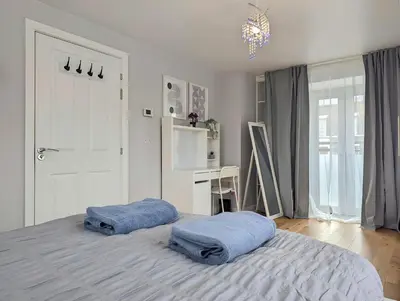 a bedroom with two blue towels on a bed at Spacious 5BR Home Near Central Liverpool Parking in Liverpool