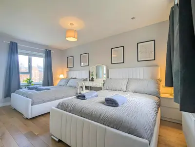 a living room with two beds and a couch at Spacious 5BR Home Near Central Liverpool Parking in Liverpool