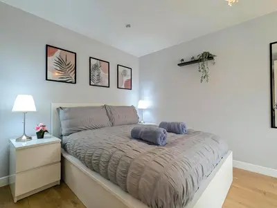 a bedroom with a bed with two pillows on it at Spacious 5BR Home Near Central Liverpool Parking in Liverpool