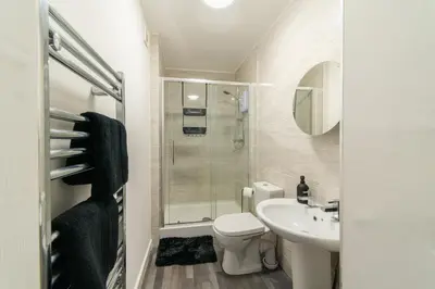 a bathroom with a toilet and a sink and a shower at Cosy 2 bed flat in Merseyside in Southport