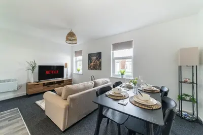 a living room with a table and a couch at Cosy 2 bed flat in Merseyside in Southport