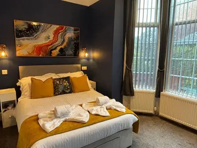 a bedroom with a bed with towels on it at Shannon suite- Home away from Home-suitable for couples, contractors and NHS- free parking in Southport