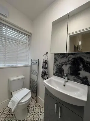 a bathroom with a white toilet and a sink at Shannon suite- Home away from Home-suitable for couples, contractors and NHS- free parking in Southport